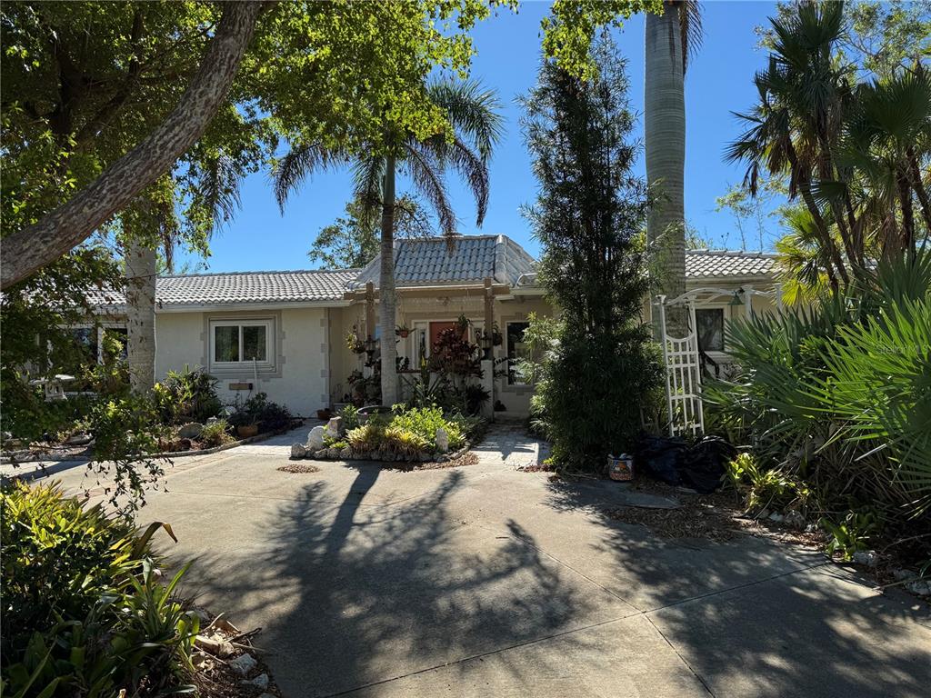 a front view of a house with a yard patio and swimming pool