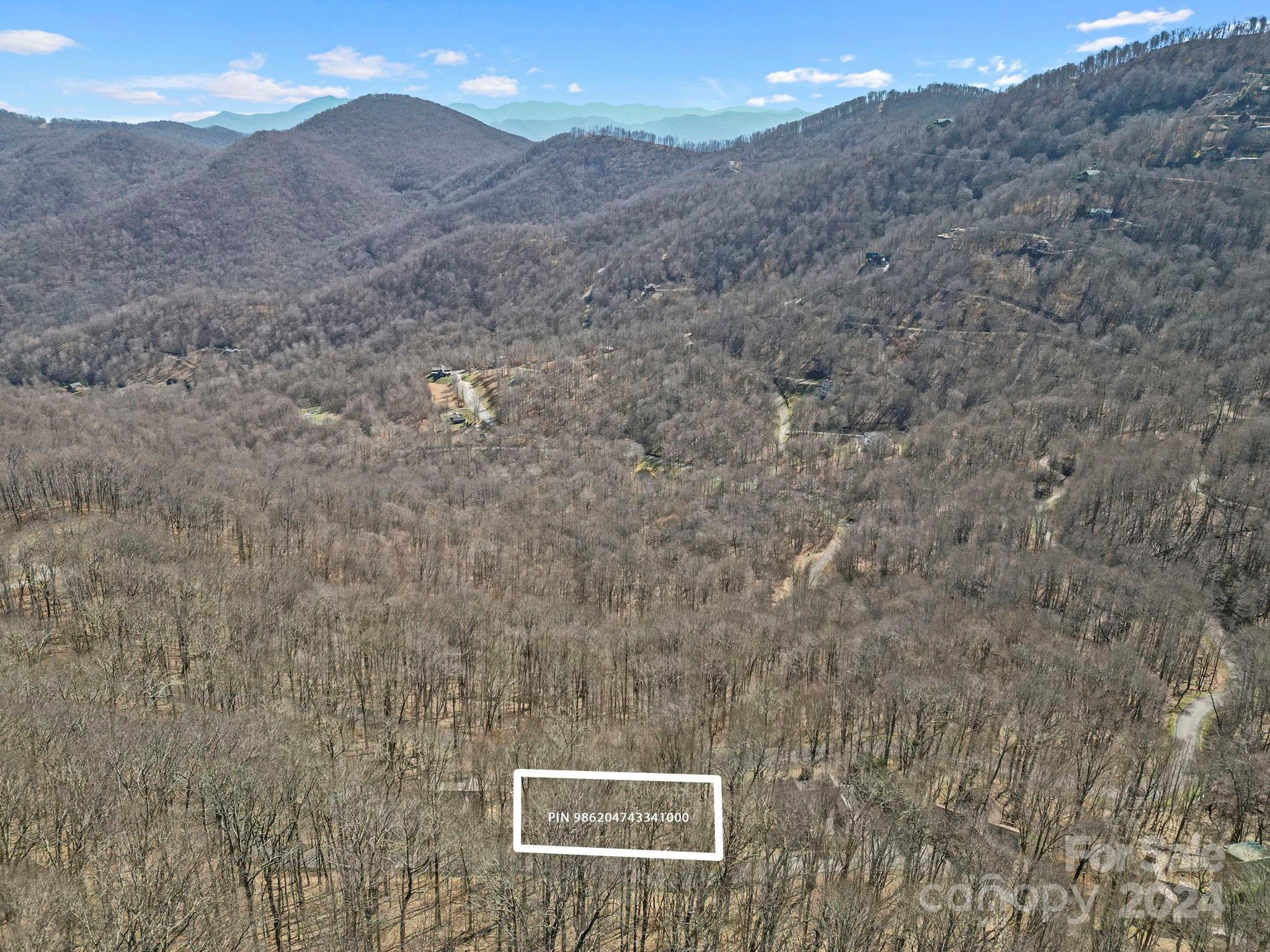 a view of a dry yard with mountains in the background