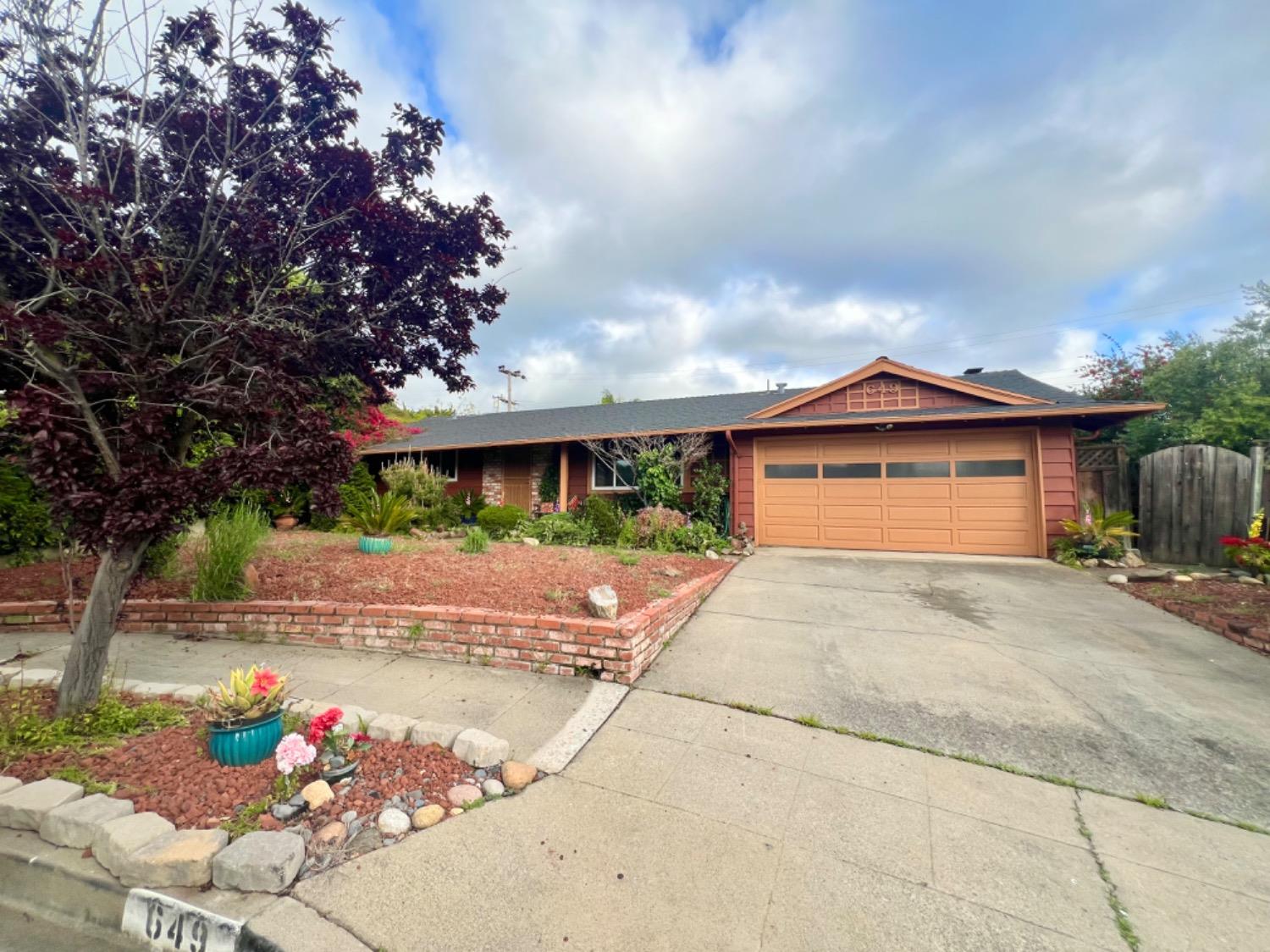 a front view of a house with a yard and a garage