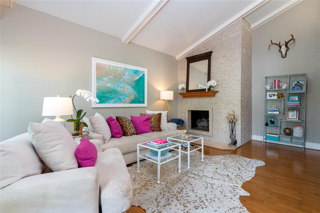 a living room with furniture a rug and a fireplace