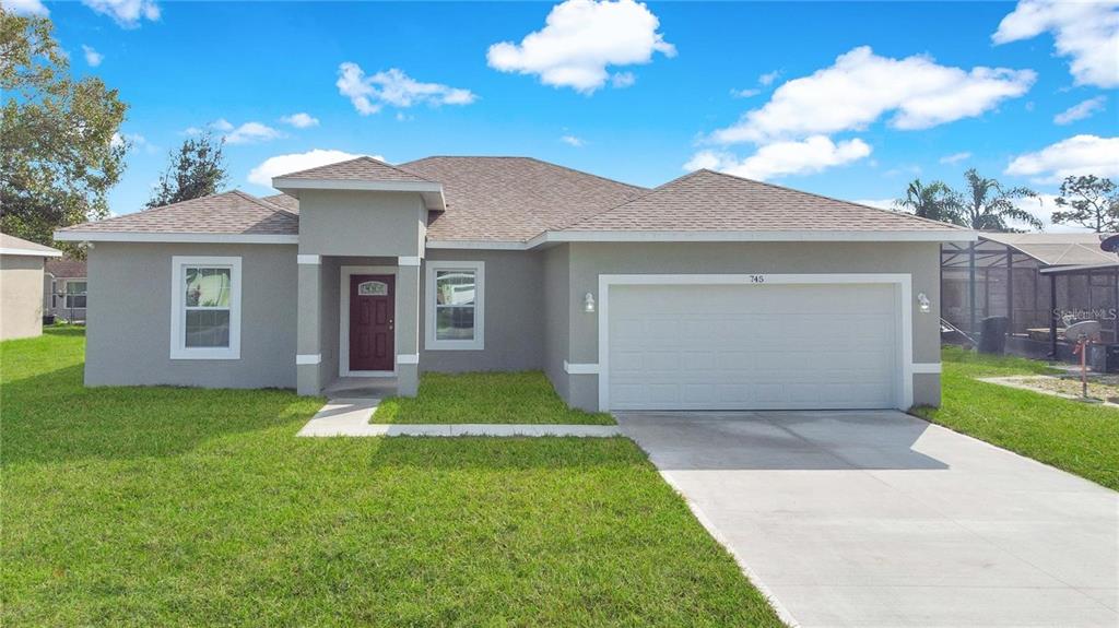 a front view of a house with a yard and garage