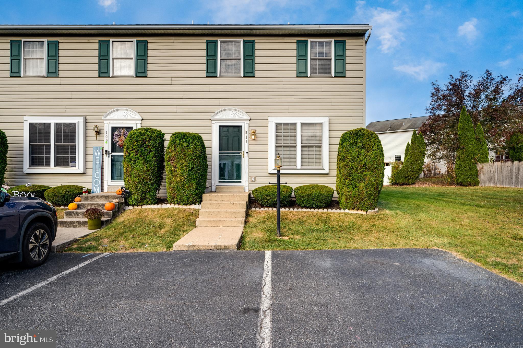 a view of a house with small yard and plants