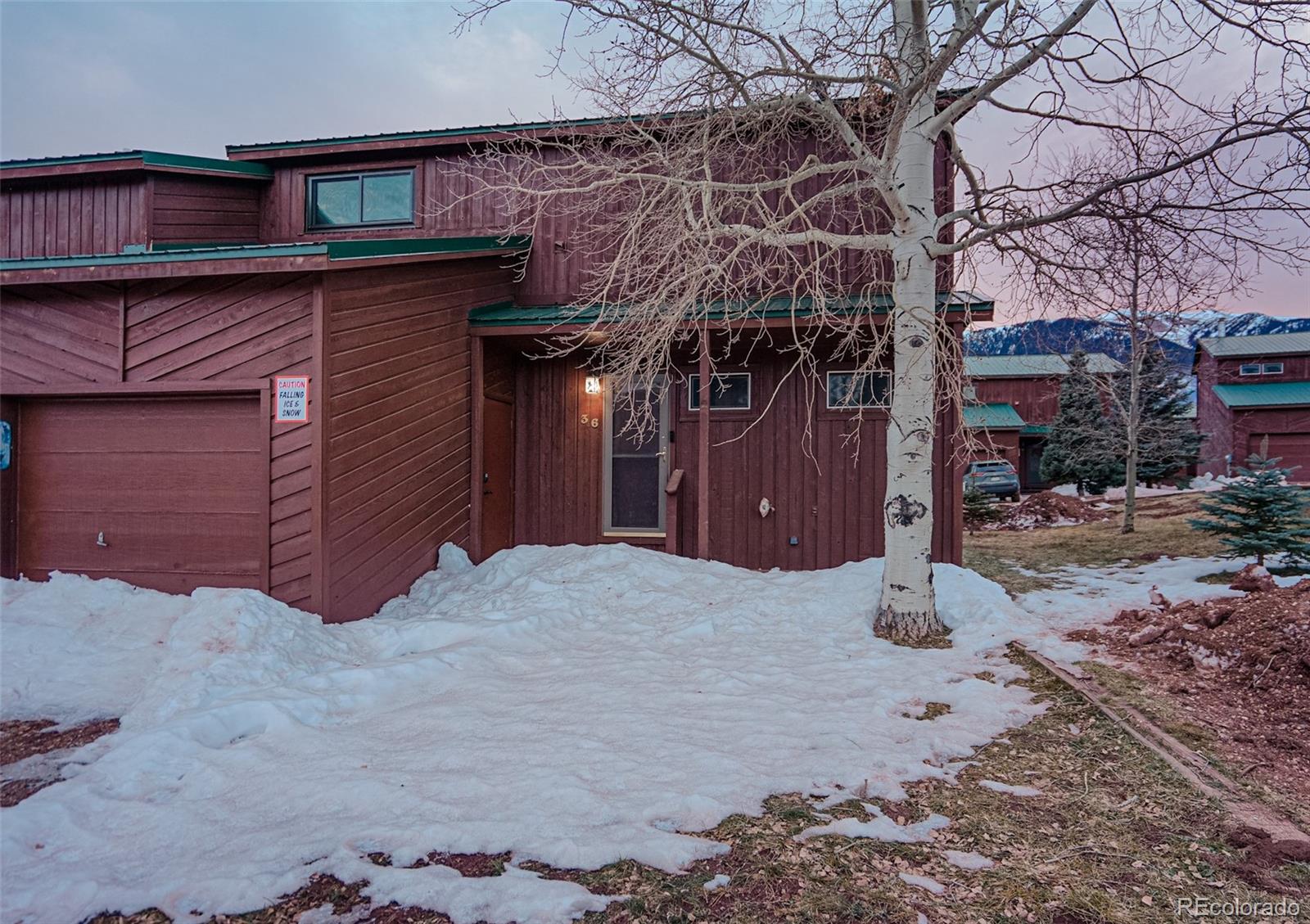 a view of a house with a snow in the yard