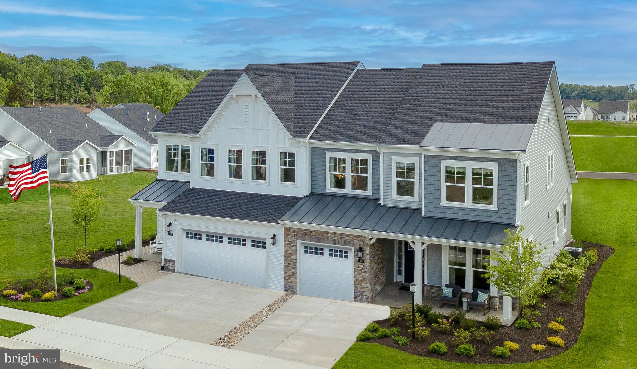 a aerial view of a house next to a yard