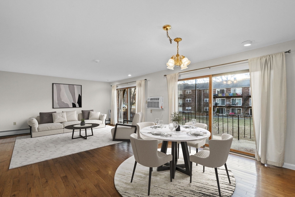 a view of a dining room with furniture window and wooden floor