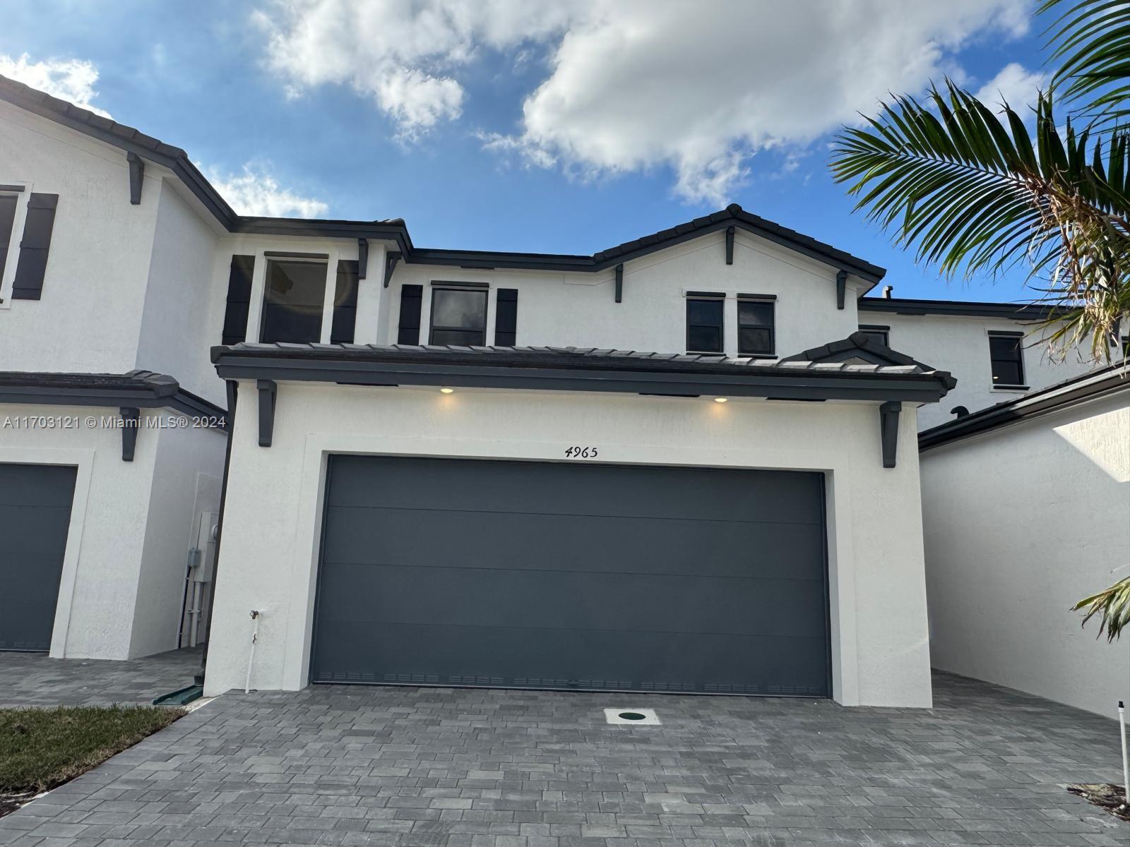 a front view of a house with a garage