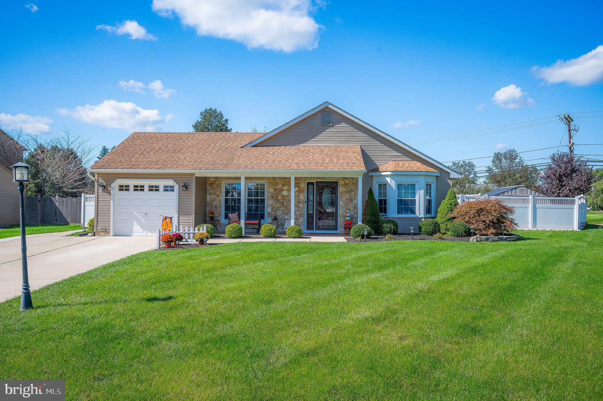 a front view of a house with a yard and porch