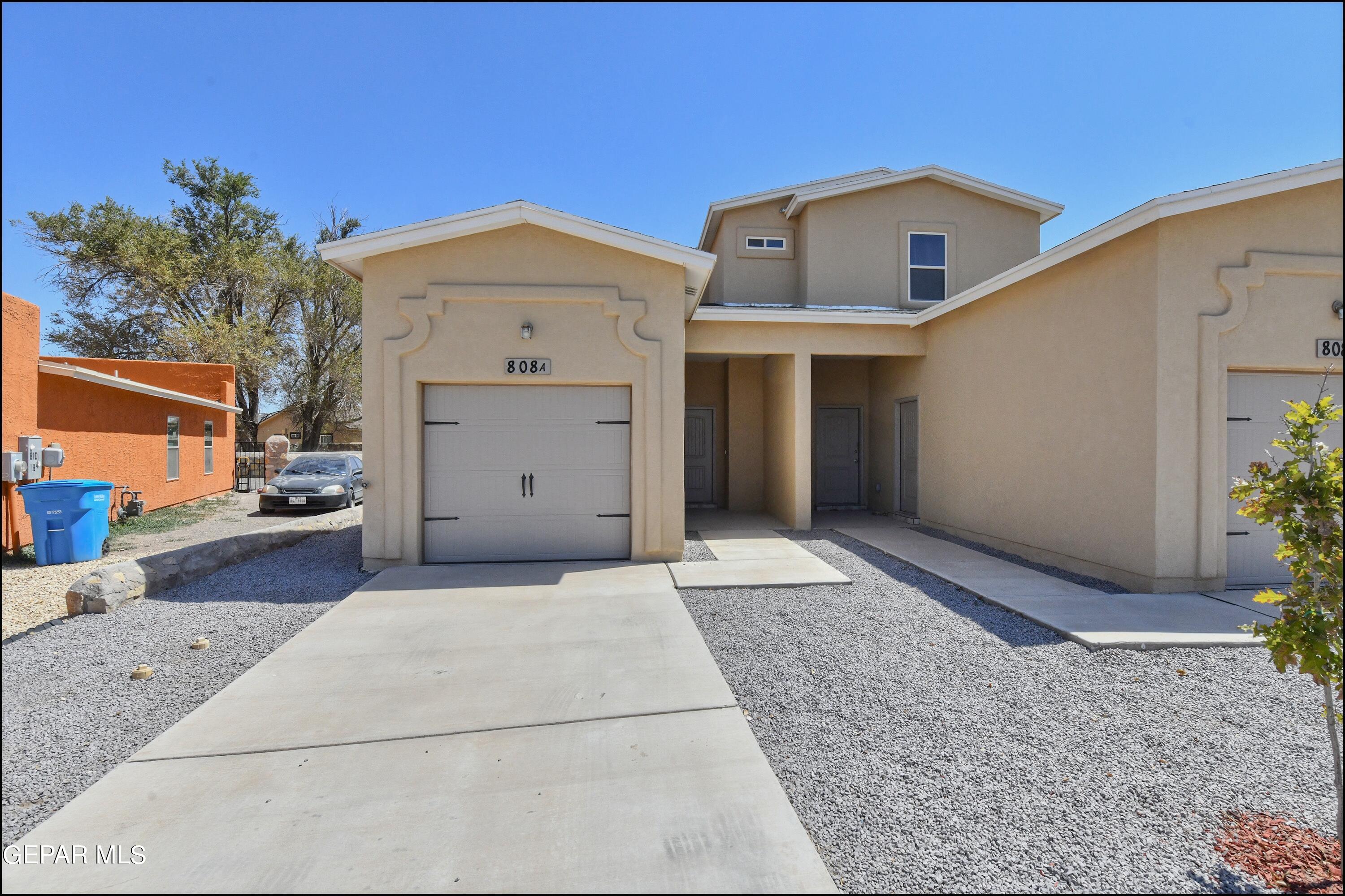 a front view of a house with a garage