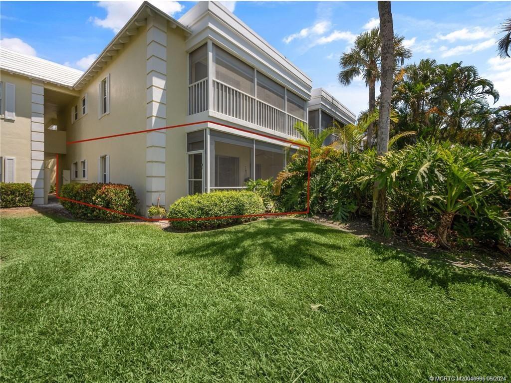 a view of a house with a backyard