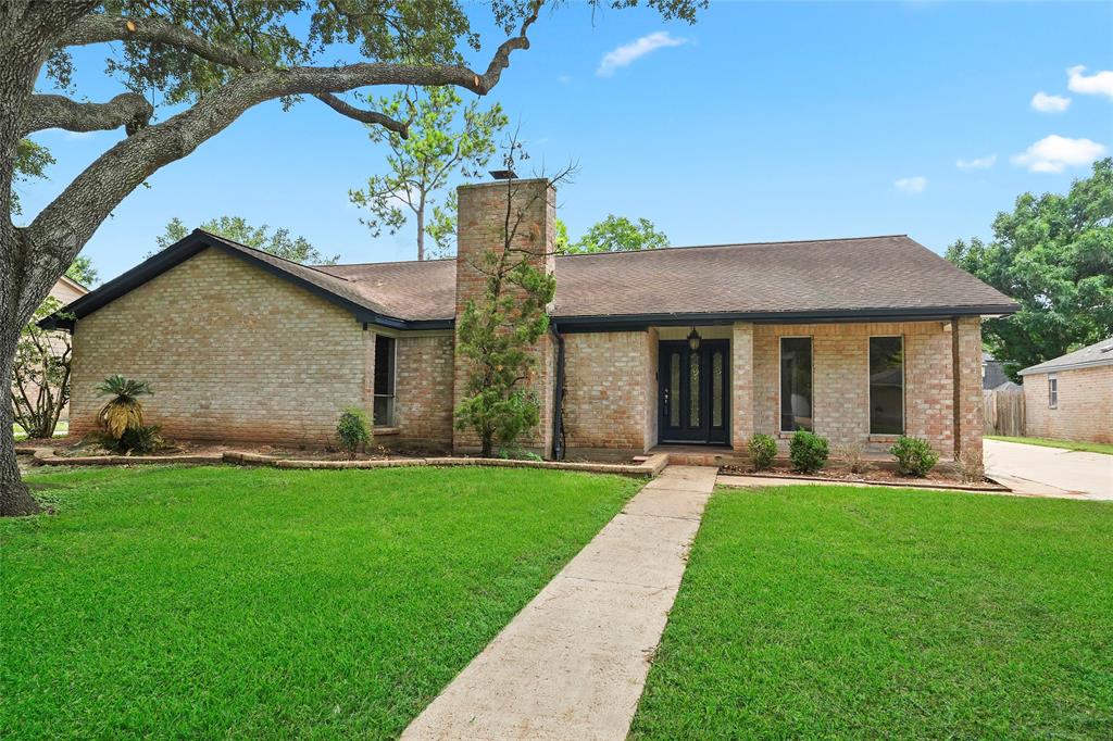 a front view of a house with a yard and porch