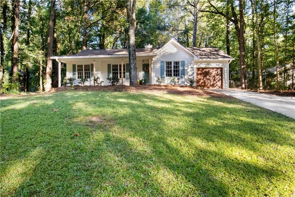 a front view of a house with yard porch and seating area