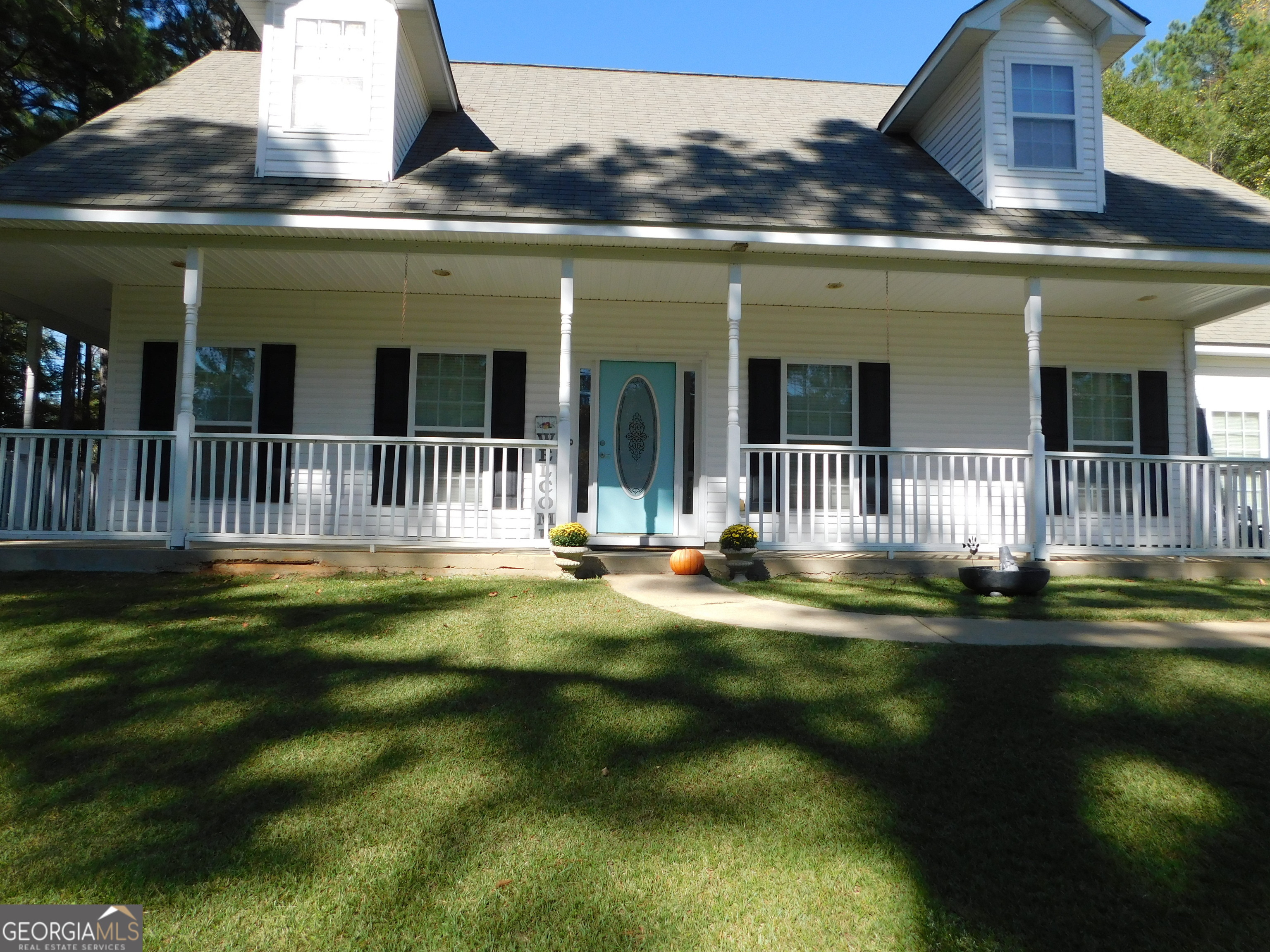 a front view of a house with a garden