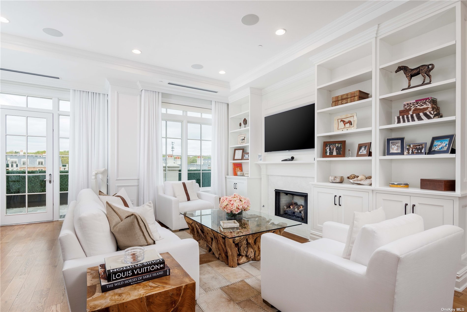 a living room with furniture a fireplace and a flat screen tv