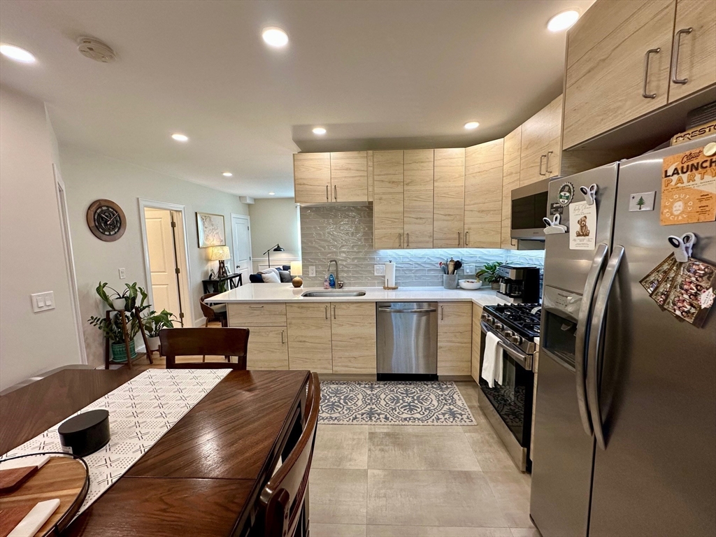 a kitchen with a sink stainless steel appliances and cabinets