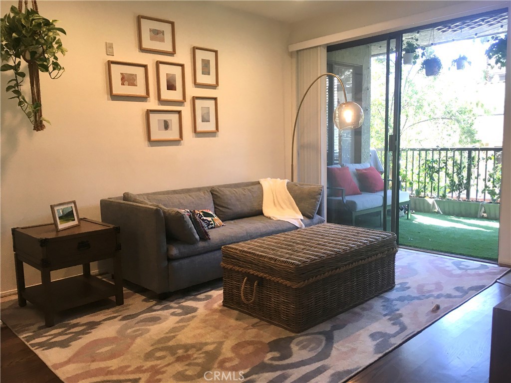 a living room with furniture and a floor to ceiling window