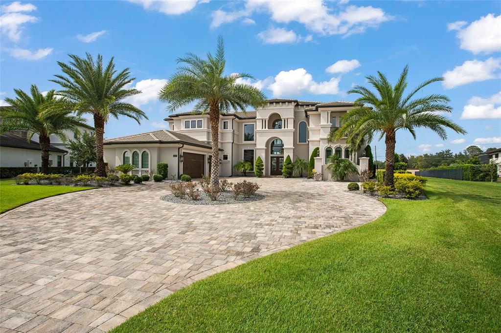 a view of a house with swimming pool and palm tree