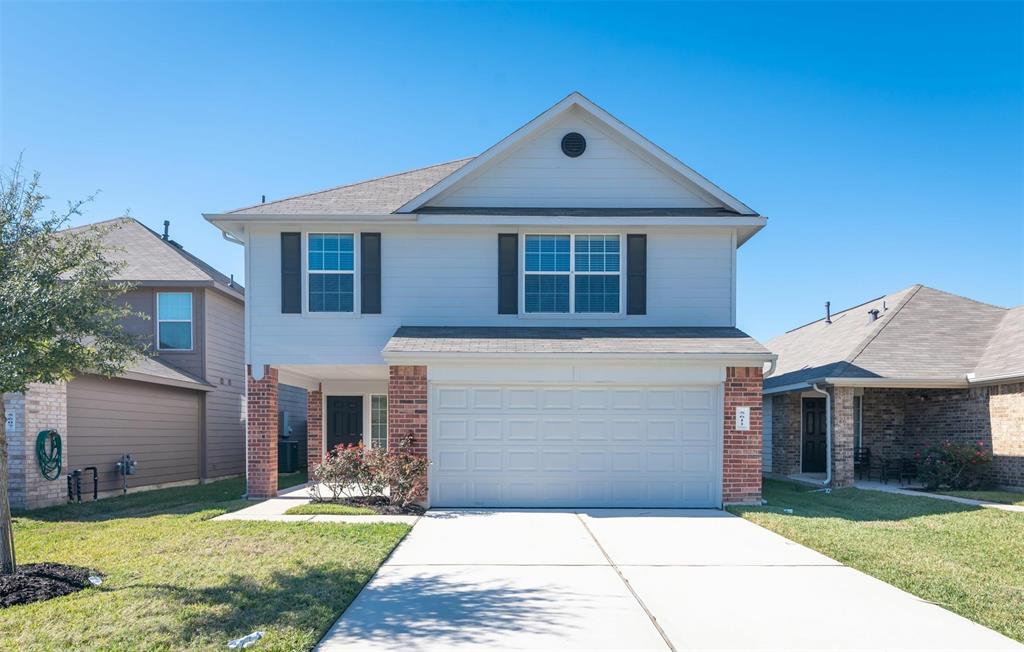 a front view of a house with a yard and garage