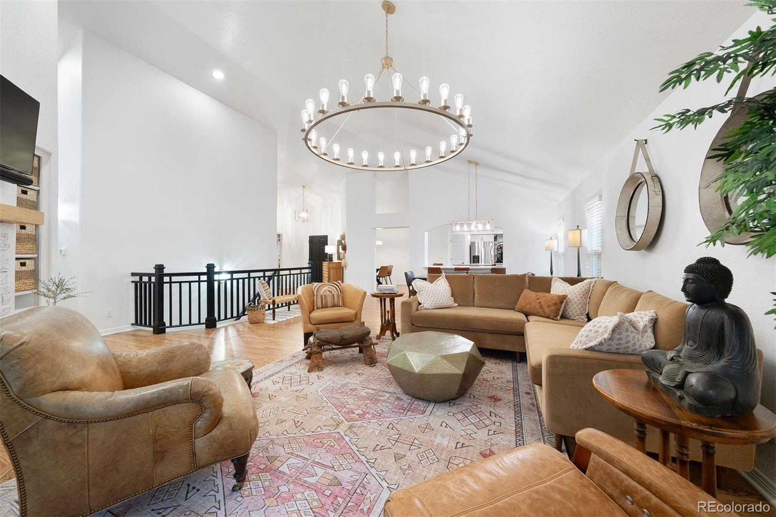 a living room with furniture a chandelier and a large mirror