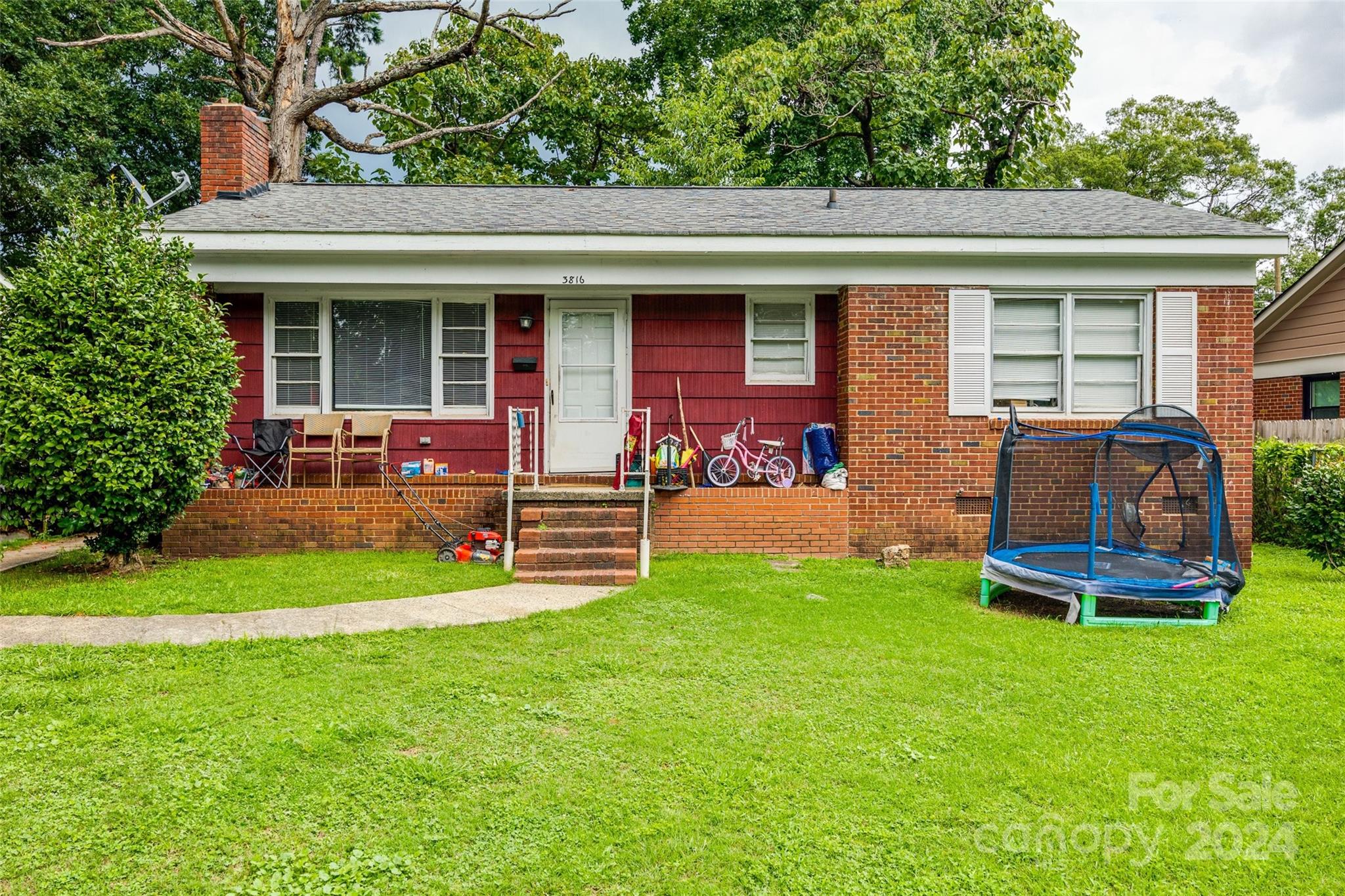 a view of a house with a yard and sitting area