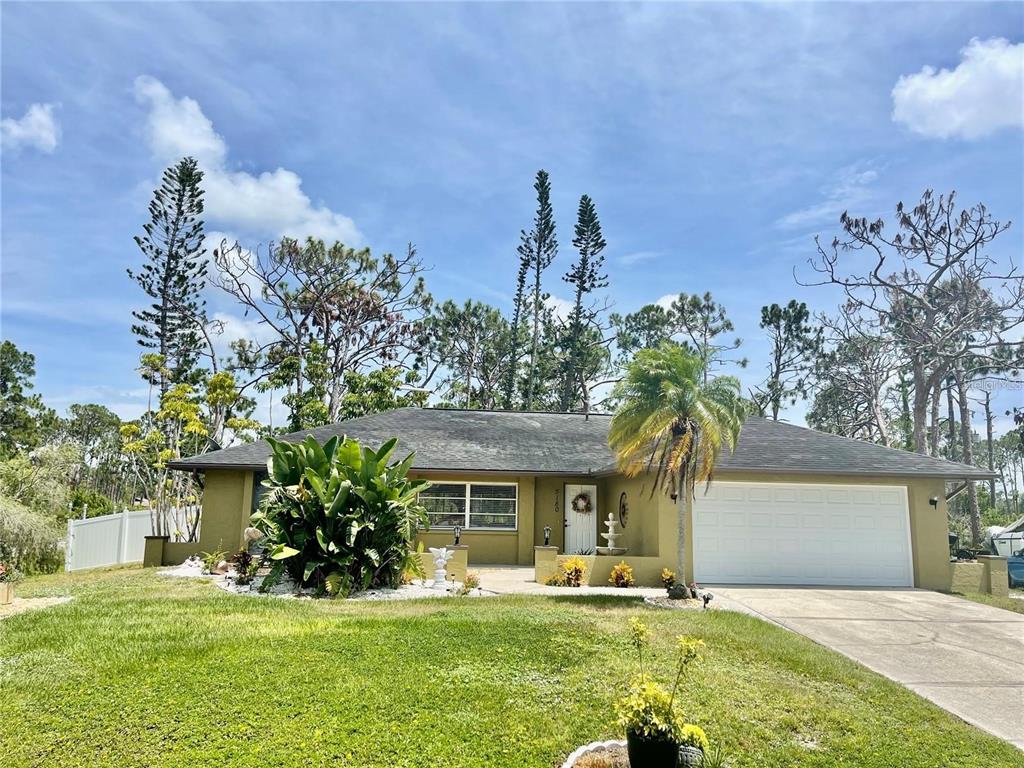 a front view of a house with a yard and a garage