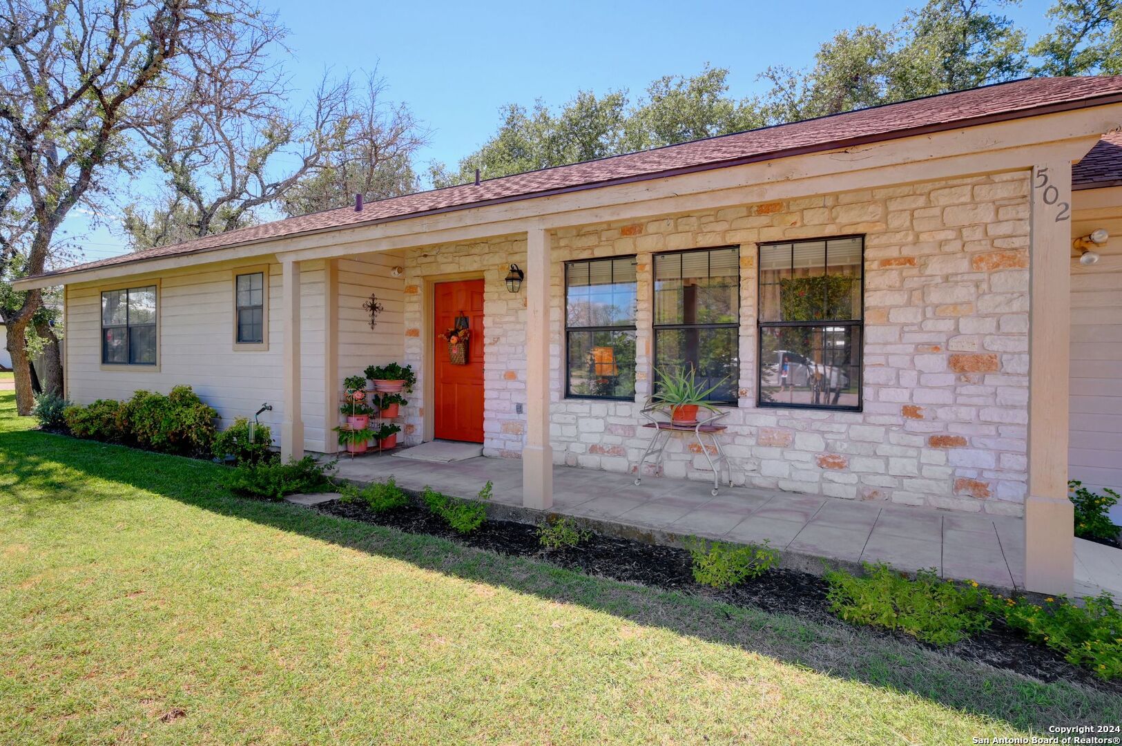 a front view of a house with garden