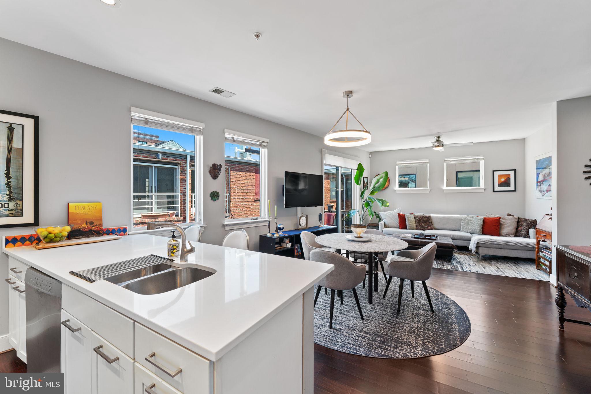 a kitchen with a table chairs and white cabinets