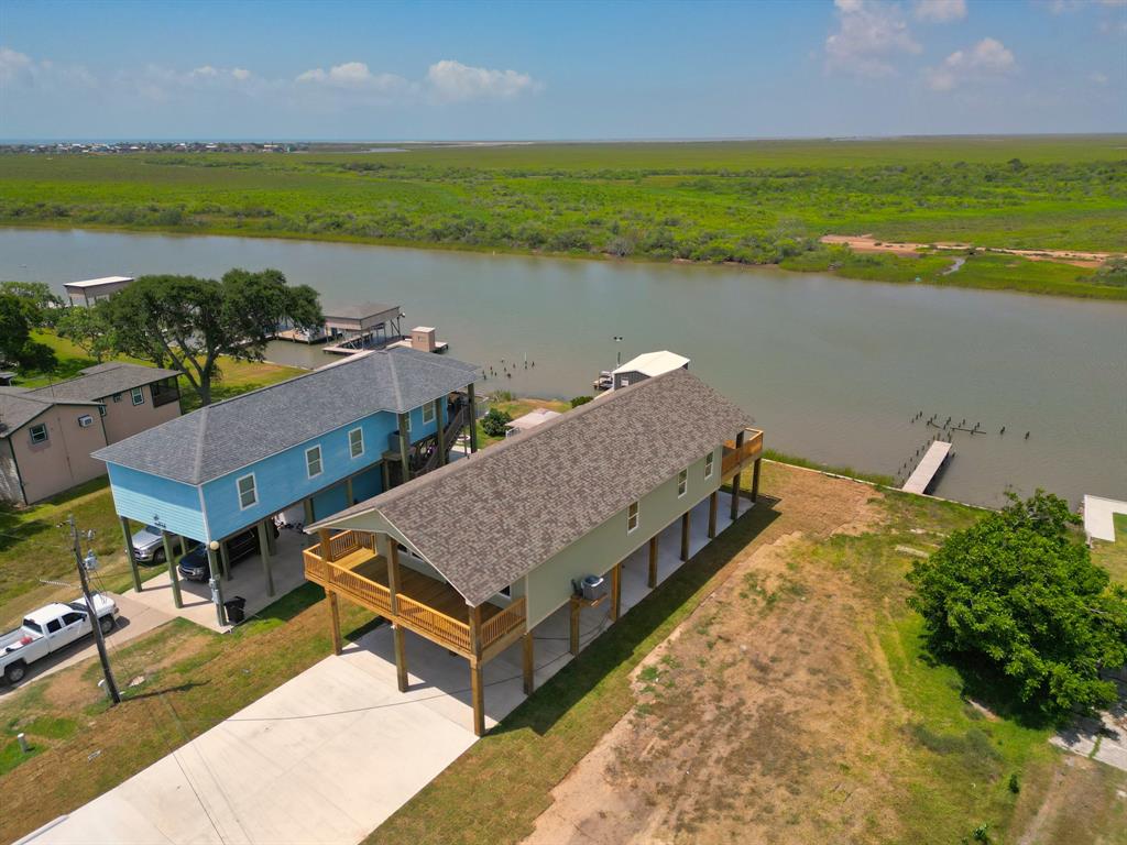 an aerial view of a house with a garden and lake view