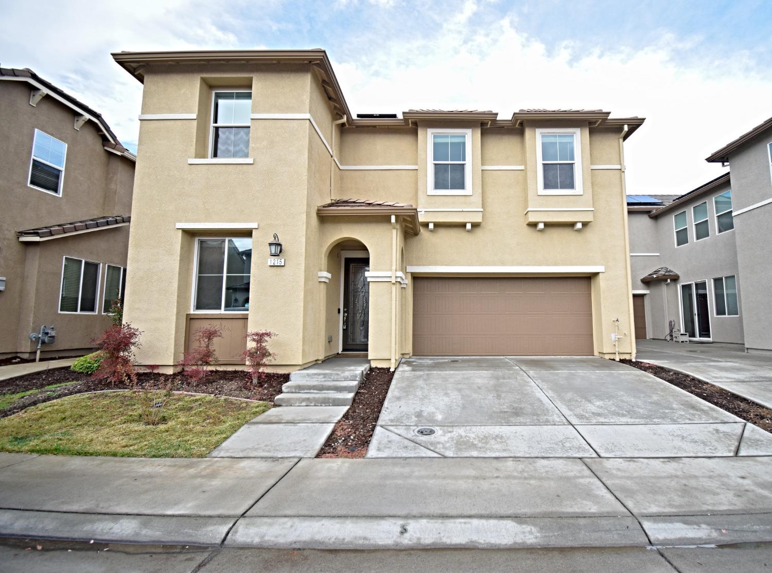 a front view of a house with yard