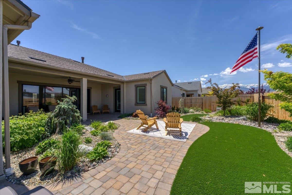 a view of a house with backyard sitting area and garden