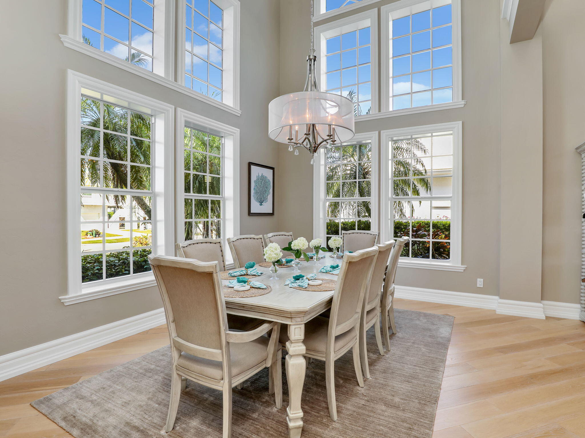 a dining room with furniture a chandelier and wooden floor