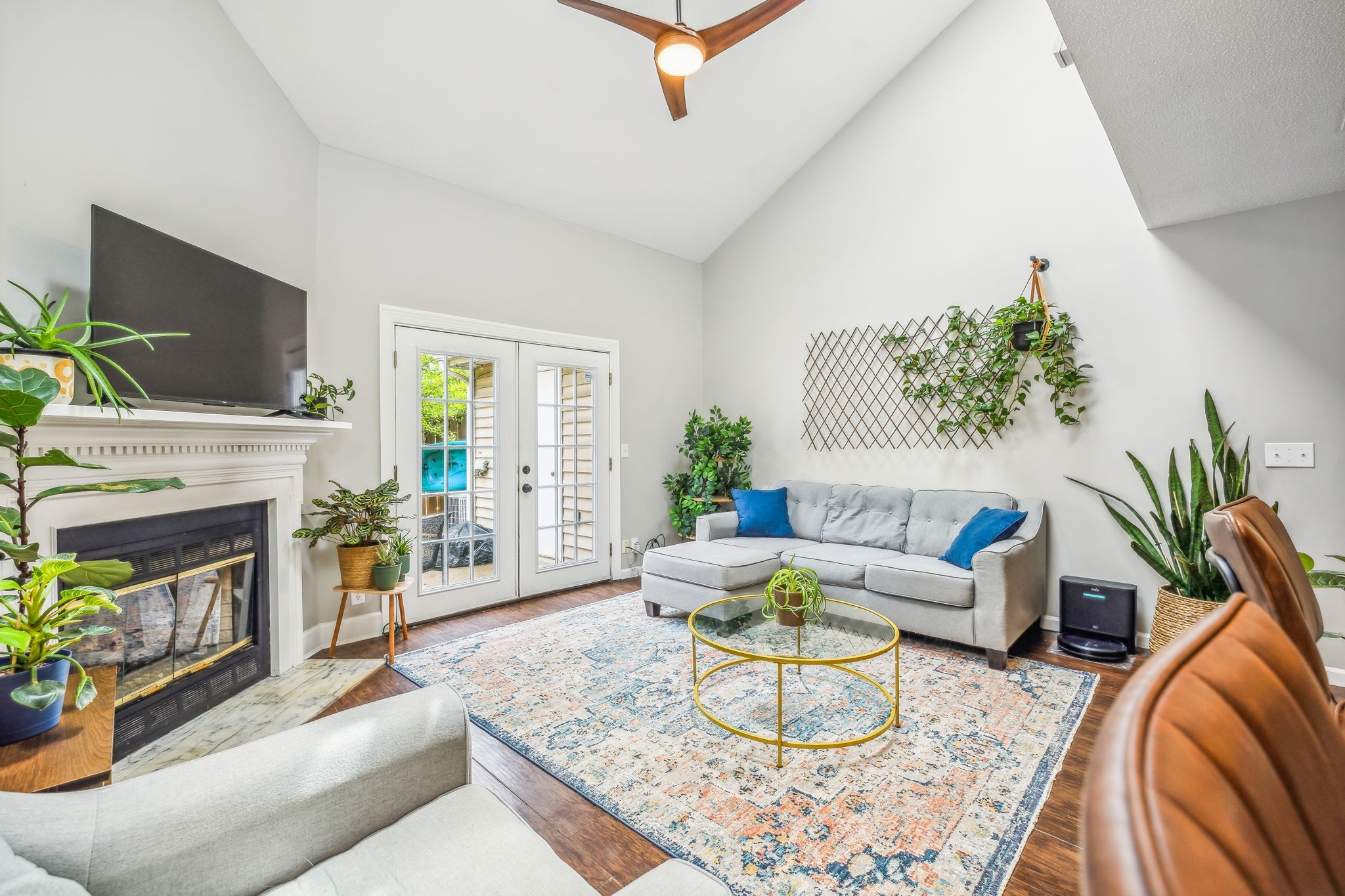 a living room with furniture a fireplace and a flat screen tv