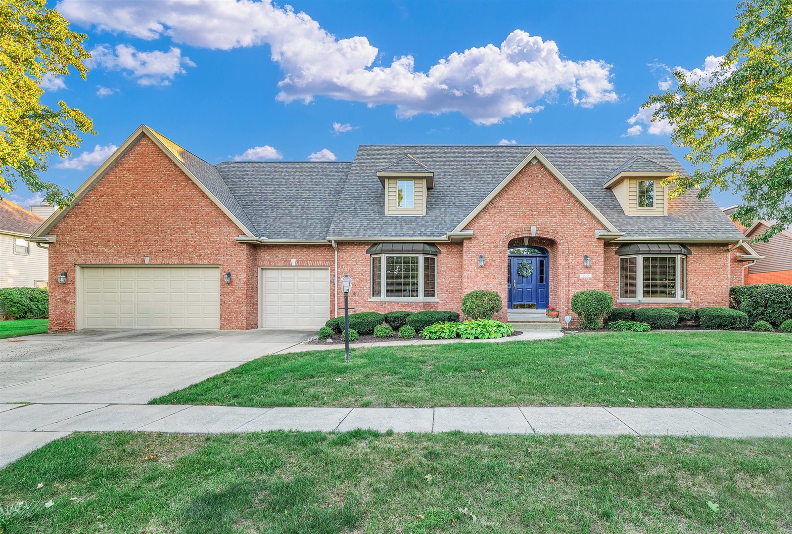 a front view of a house with a yard and garage