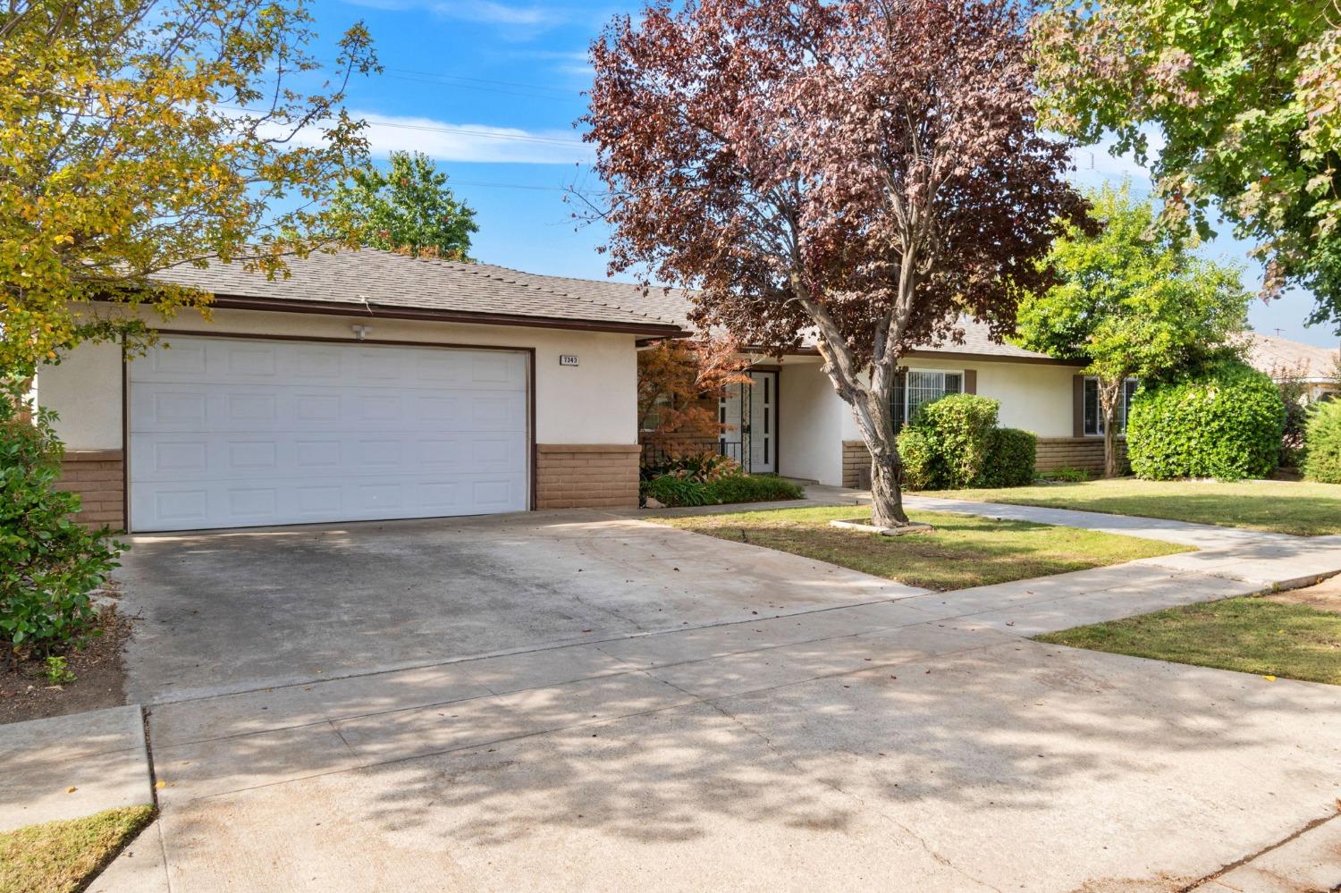 a view of a house with a yard and garage