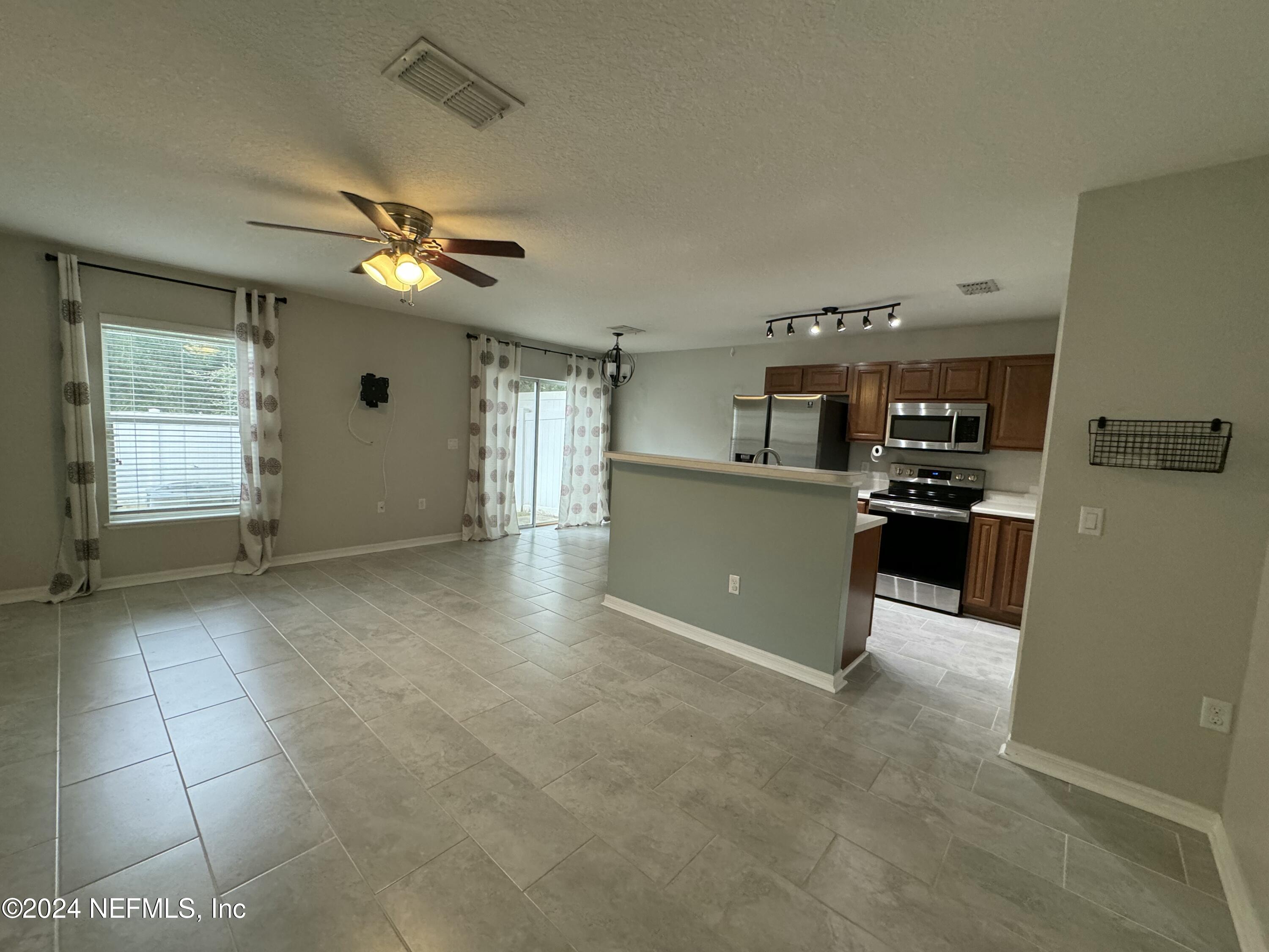 a large kitchen with cabinets and stainless steel appliances