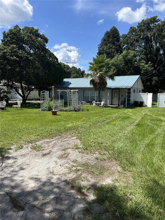 a front view of a house with a yard and trees