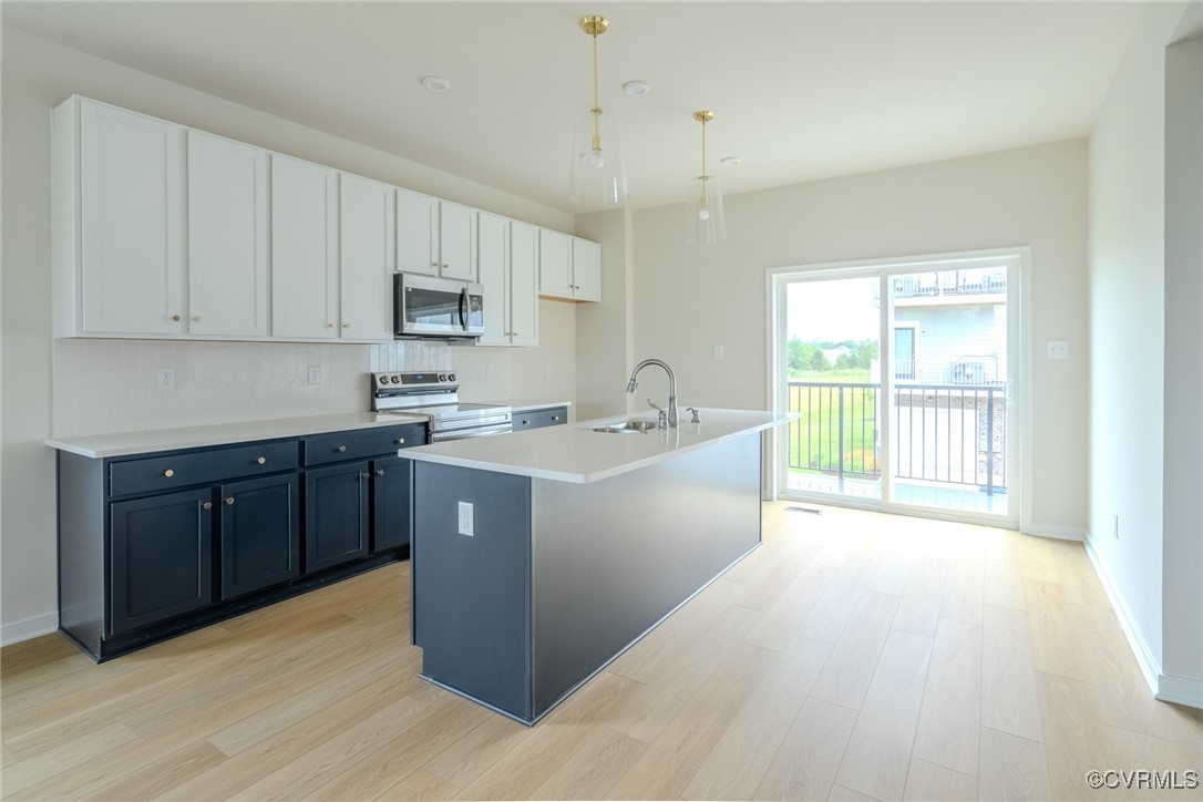 a kitchen with a sink cabinets and window