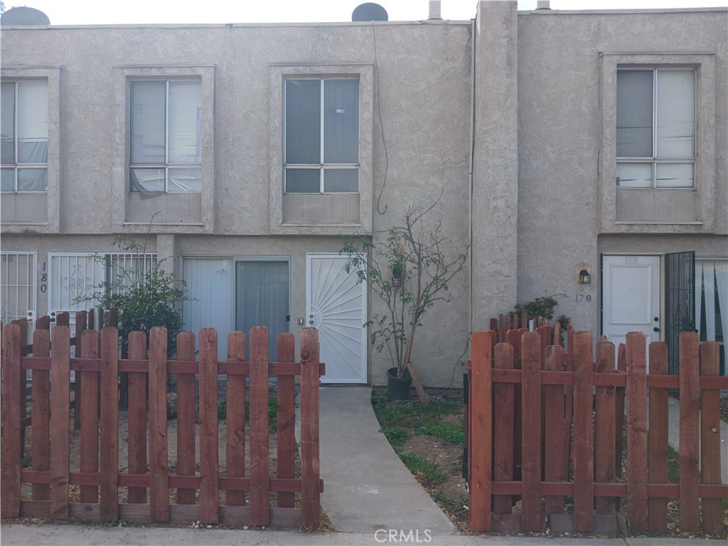 a view of a house with wooden fence