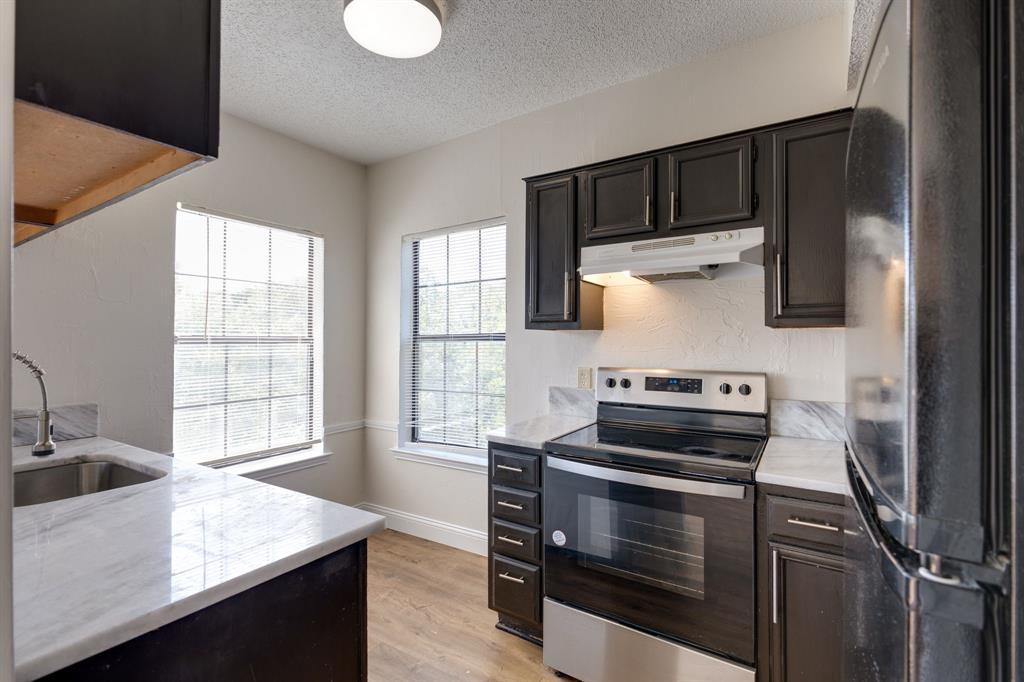 a kitchen with wooden cabinets and a stove top oven