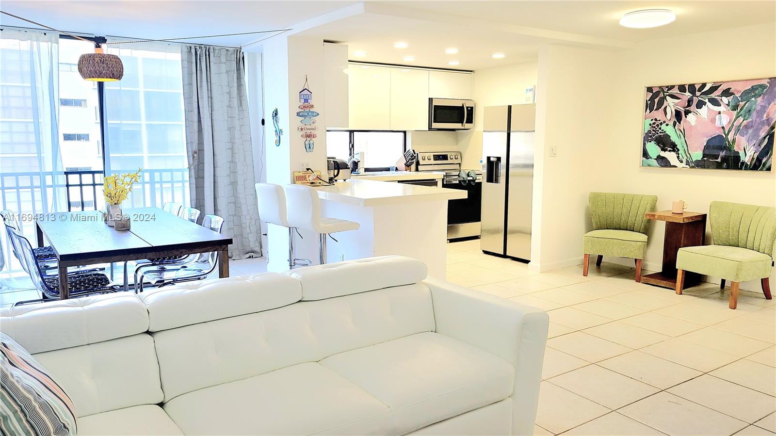 a living room with furniture and a open kitchen view