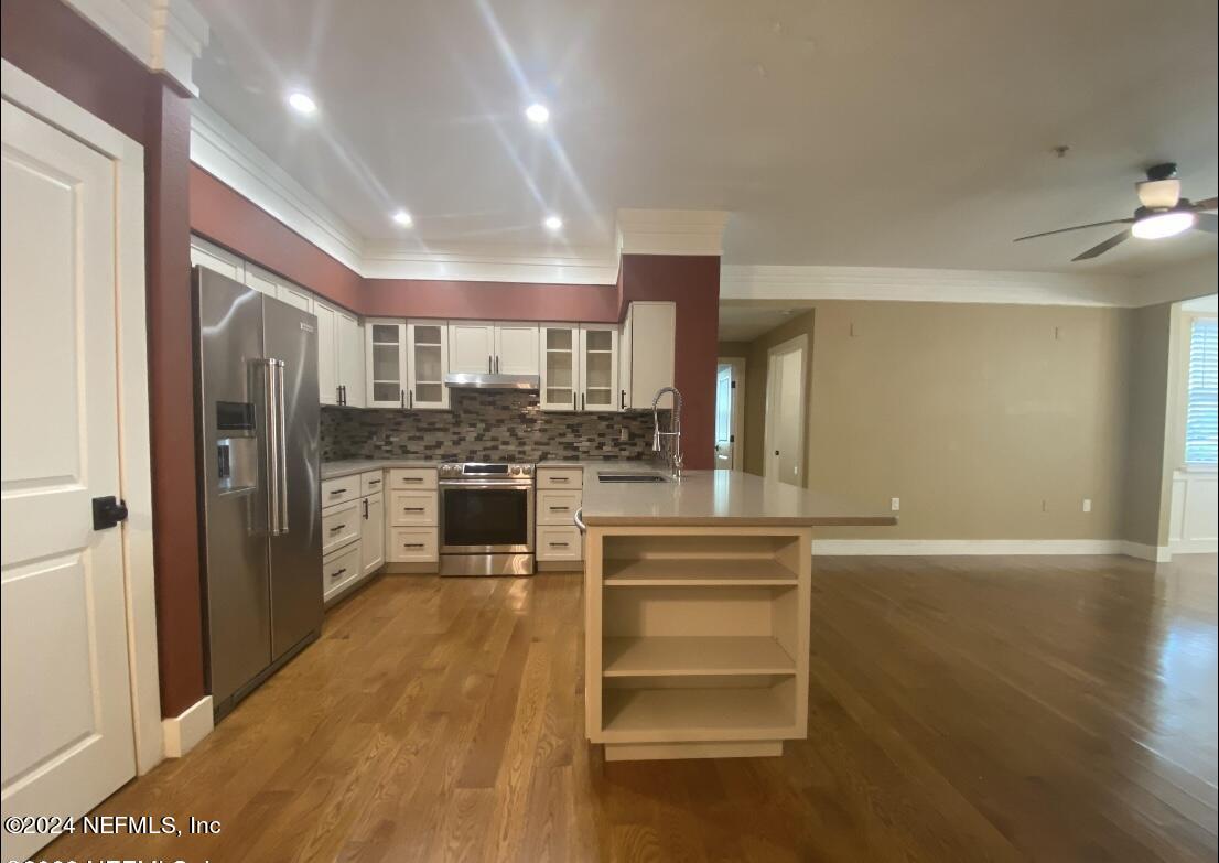 a kitchen with stainless steel appliances a refrigerator and cabinets