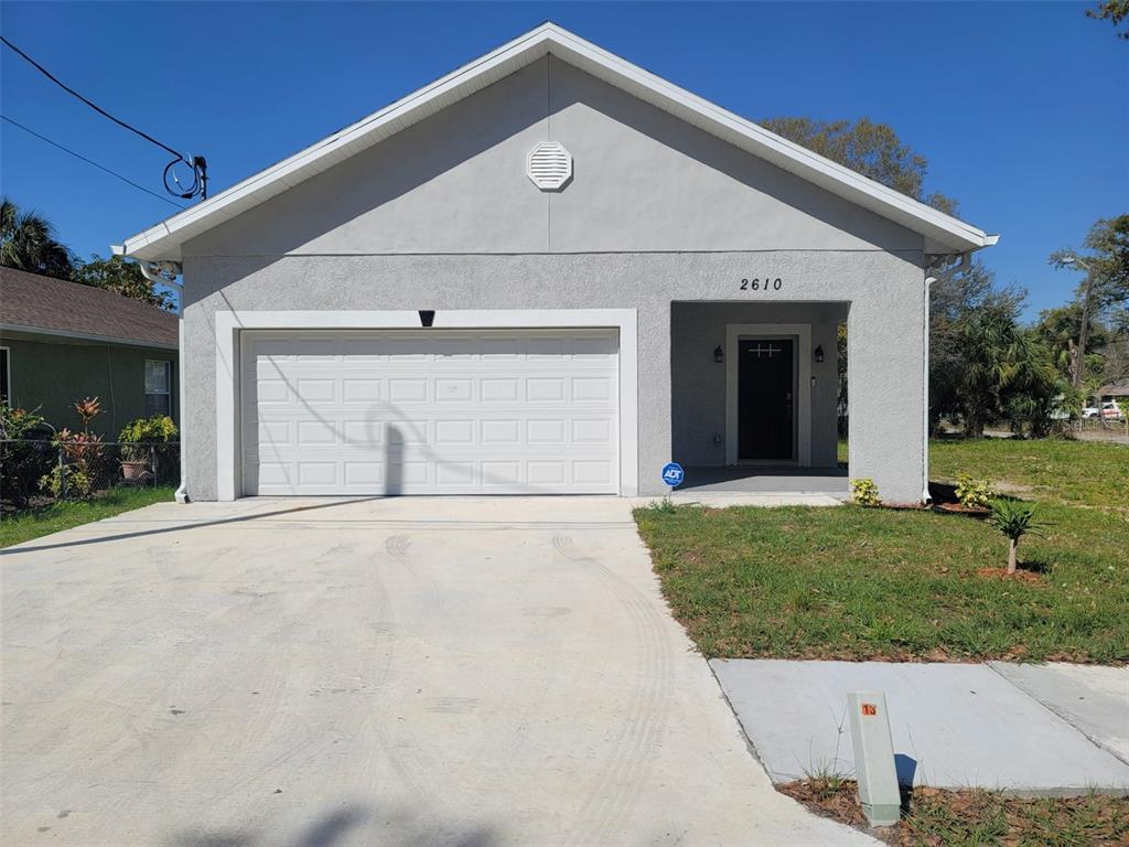 a front view of a house with a yard and garage