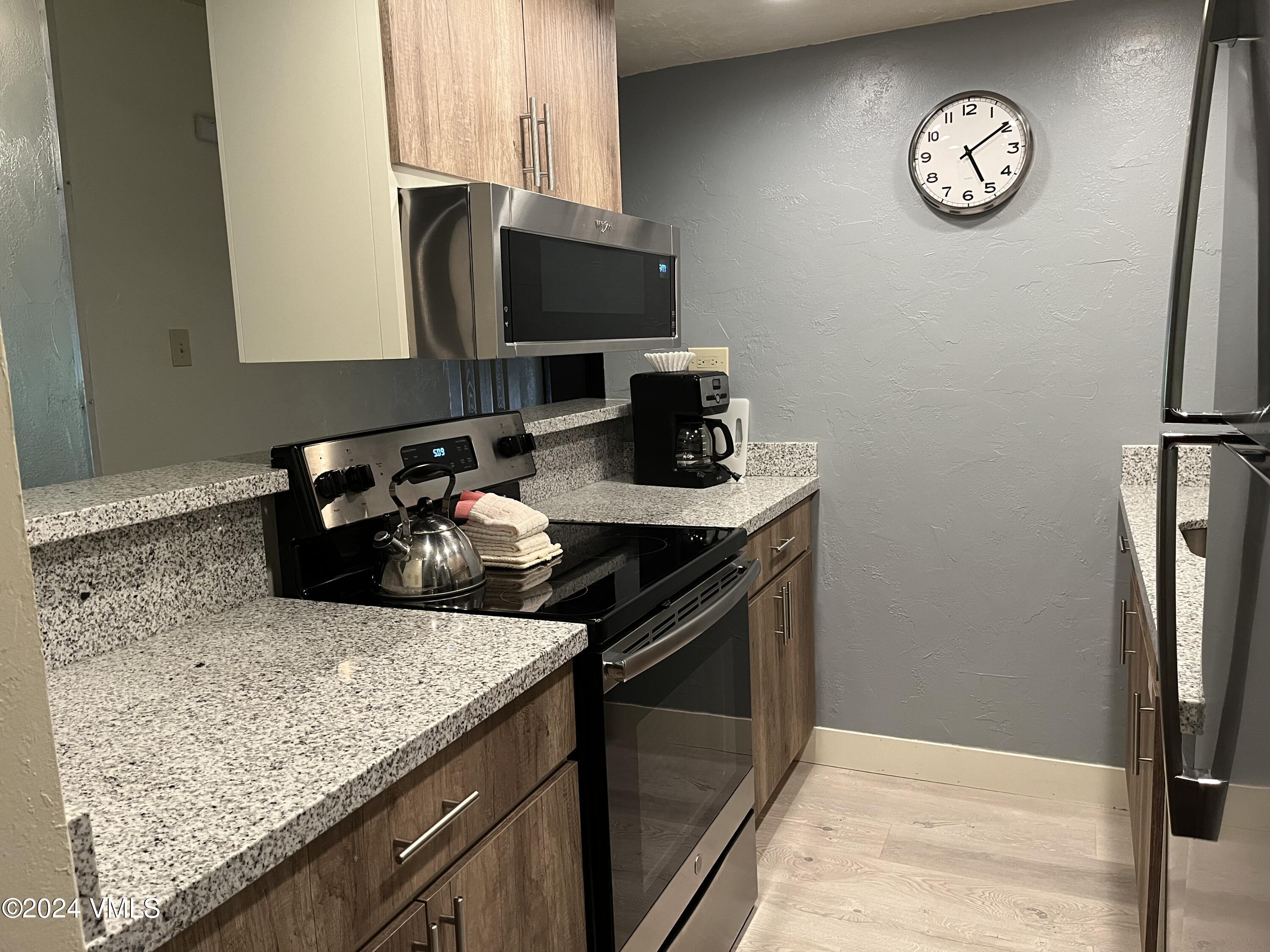 a kitchen with a sink appliances and a counter top space