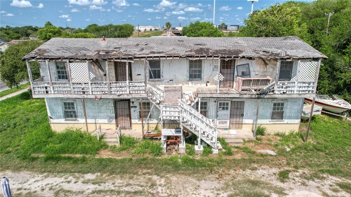 a aerial view of a house with a yard table and chairs