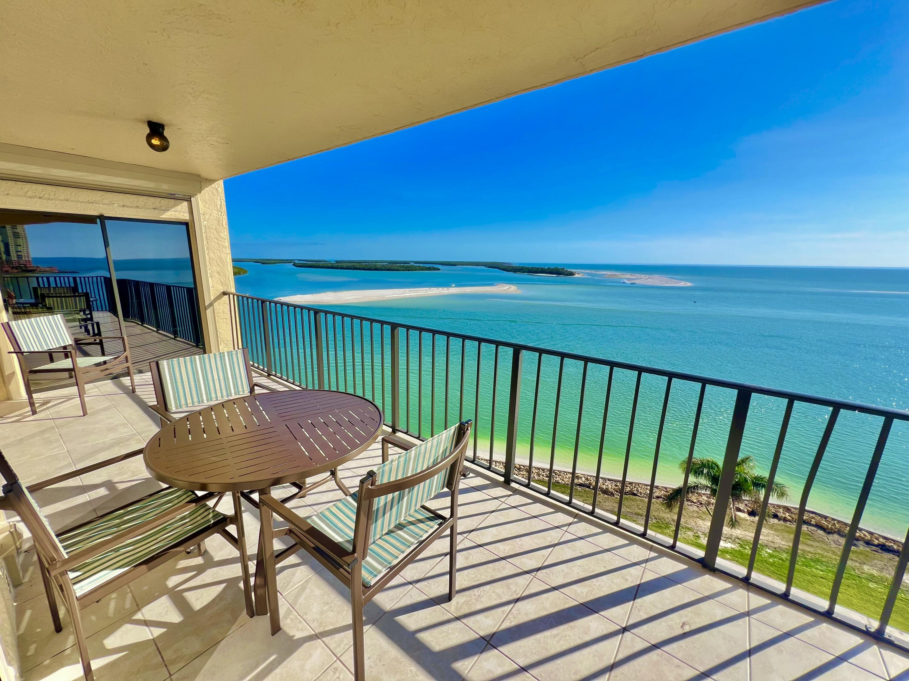 a view of balcony with table and chairs