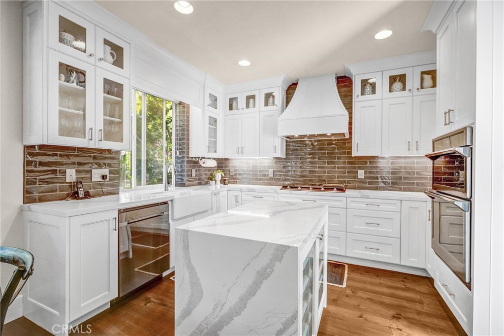 Fully renovated, DESIGNER kitchen with soft close cabinetry all the way to the ceiling, pot drawers, lazy Susans, wine rack, porcelain farmhouse sink, Black stainless steel appliances, Quartz countertop, waterfall island, kitchen sink window, and a Pantry!  Immaculate condition!