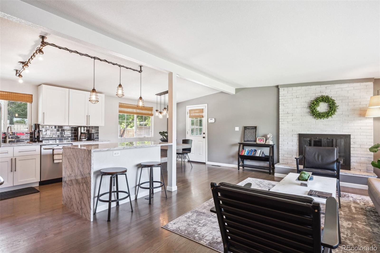 a open kitchen with stainless steel appliances granite countertop a stove and a refrigerator