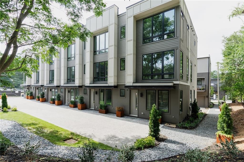 a view of a building with a yard and plants