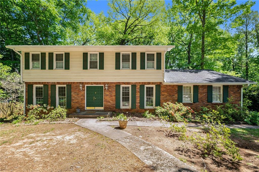 a front view of a house with yard patio and green space