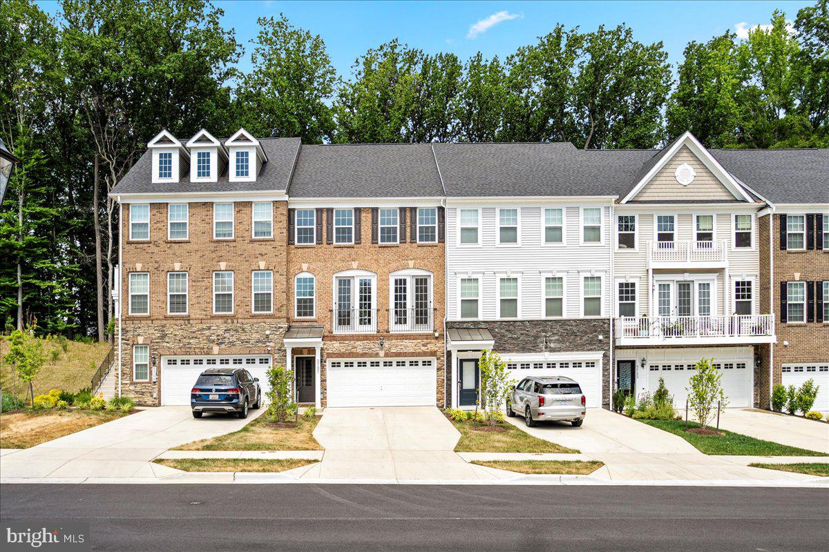 a front view of a residential apartment building with a yard