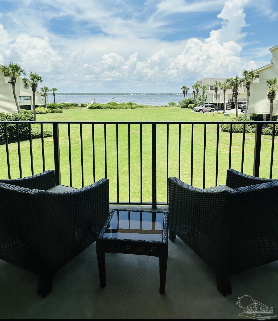 a view of a two chairs in the balcony